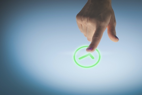 Hand pressing a green tick on an interactive screen
